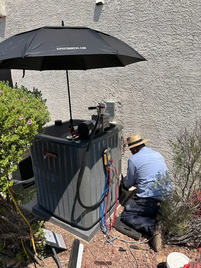 HVAC technician performing outdoor AC maintenance in Orangetree